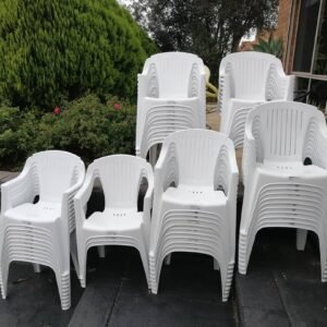 Stacks of white garden chairs